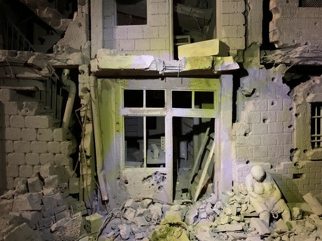 woman between ruins syria